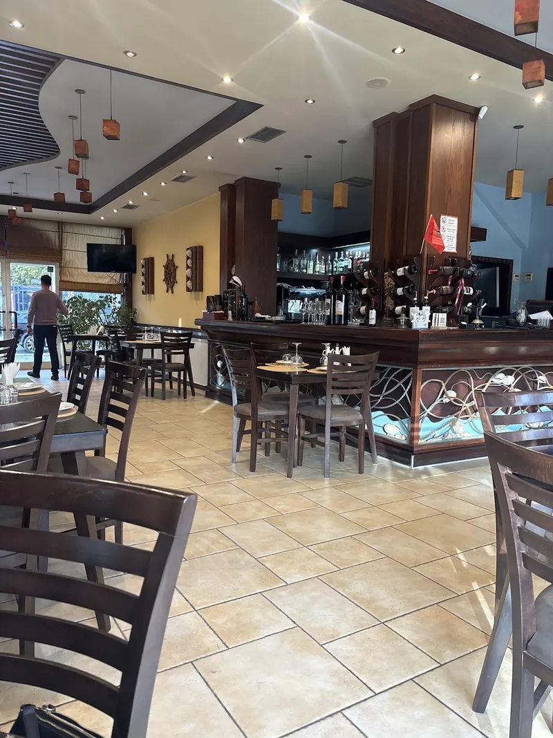 The bright dining room with wooden chairs and the bar